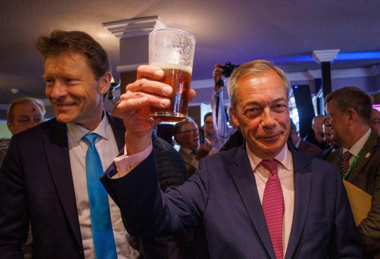 Reform Leader Nigel Farage has a pint with Chairman Richard Tice in Clacton on Sea where Farage is standing as a candidate. Photo: Mark Thomas / Alamy