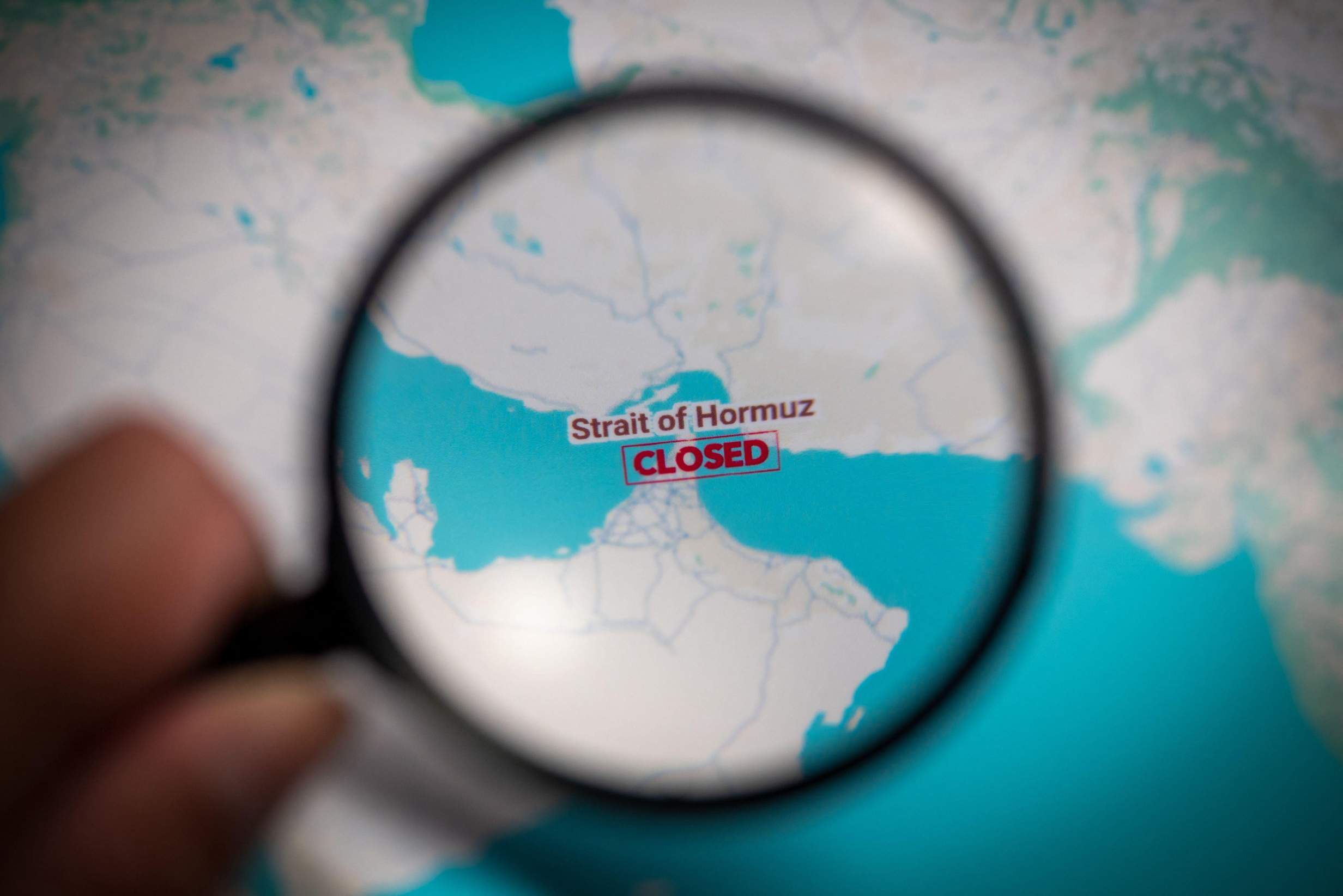 Strait of Hormuz Closed Mark Highlighted on Map with Magnifying Glass