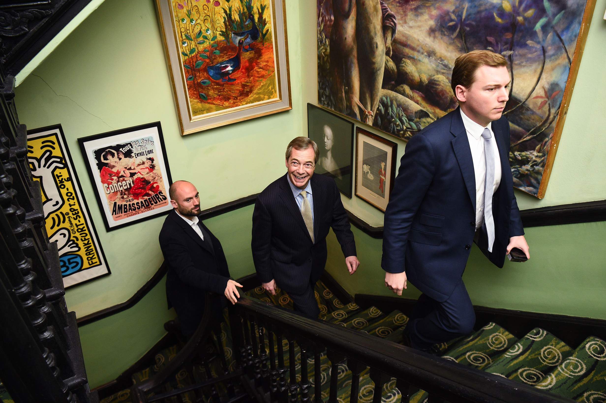 File photo dated 30/01/20 of Nigel Farage walks up the stairs behind George Cottrell as he arrives to watch the unveiling of a portrait of himself titled Mr Brexit, by artist Dan Llywelyn Hall, at L'Escargot Restaurant in London. Reform UK leader Nigel Farage has resigned as MP for Clacton, saying he will fight the forthcoming by-election. Issue date: Tuesday July 07, 2026. - Image ID: 3F0AM4N